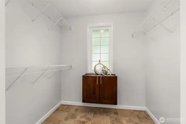 Primary with large walk in closet with window for natural light.