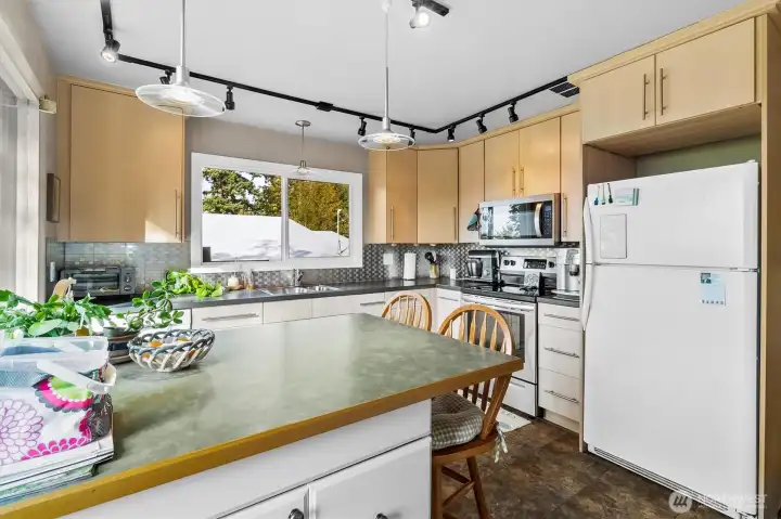 Kitchen with sleek cabinetry, ample prep space, and easy flow to the dining area.