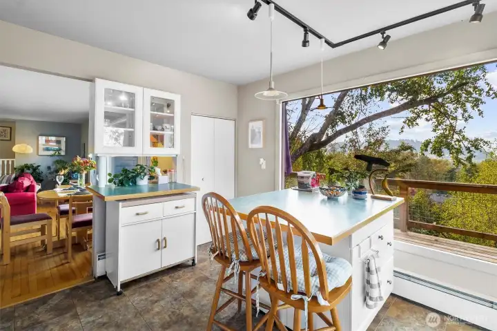 Charming breakfast nook surrounded by windows, offering beautiful views while you enjoy your morning coffee.
