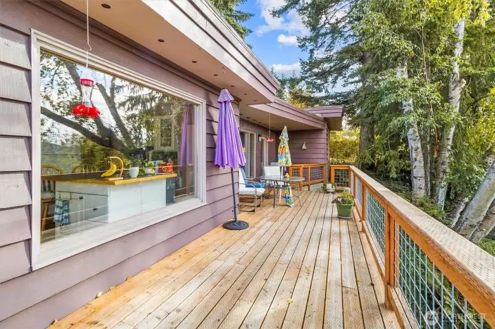 Spacious wraparound deck designed for entertaining and soaking in forest views.