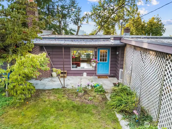 Private front yard setting, surrounded by mature landscaping for privacy.