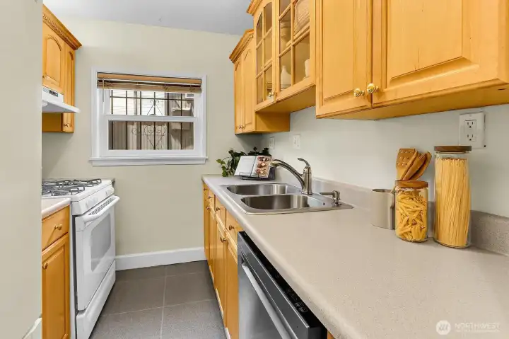 Kitchen has lots of counter space and a four burner gas cooktop.