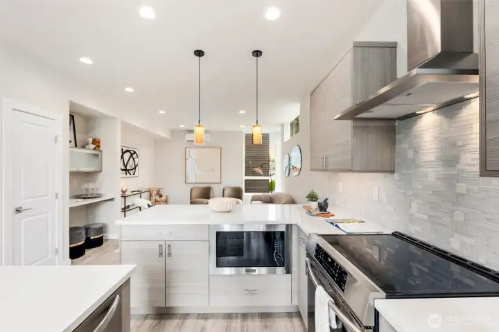 Large kitchens in both plans.  Each kitchen features BOTH an island AND peninsula + stainless appliance package + stone backsplash + quartz-topped counters + amazing storage + under cabinet lighting + separate dining spaces.