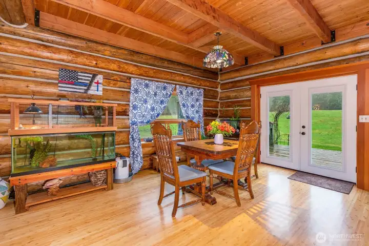 Open dining room with double doors to the back deck