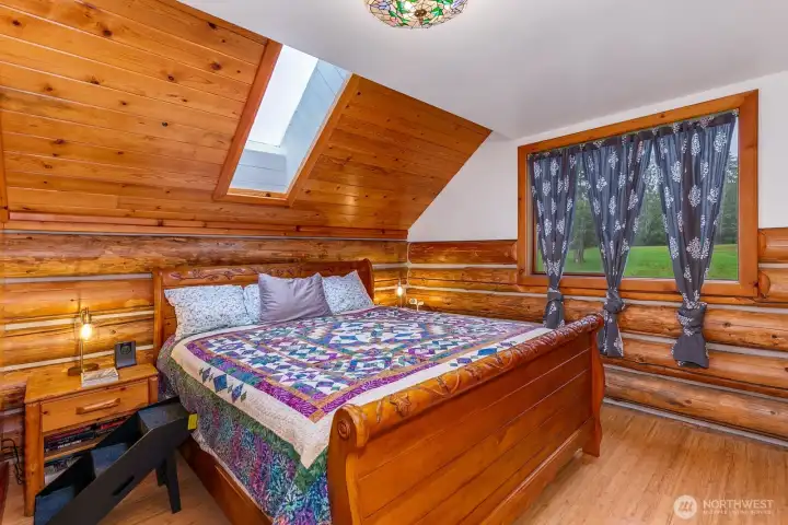 Primary bedroom offers sky lights and beautiful wood work