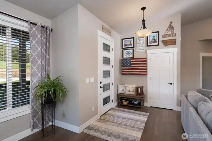 Bright foyer with modern front door and natural light