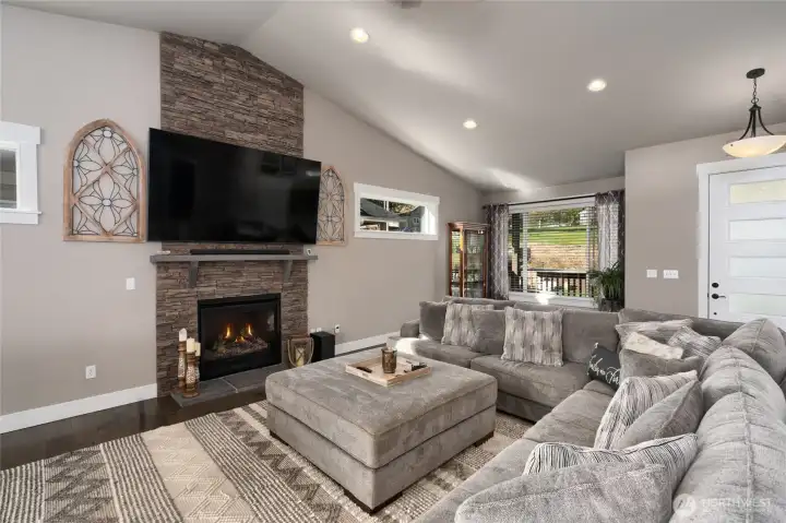 Cozy living room with stone fireplace and large sectional seating