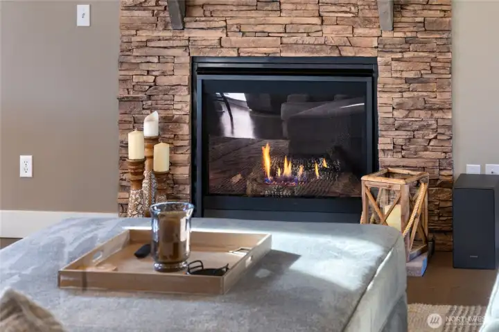 Stylish gas fireplace with stacked stone surround and warm ambiance