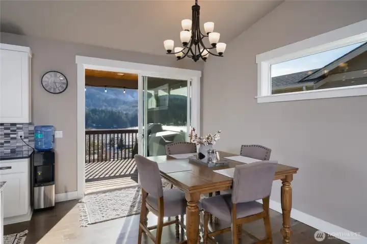 Dining area with lake views, sliding door, and modern lighting