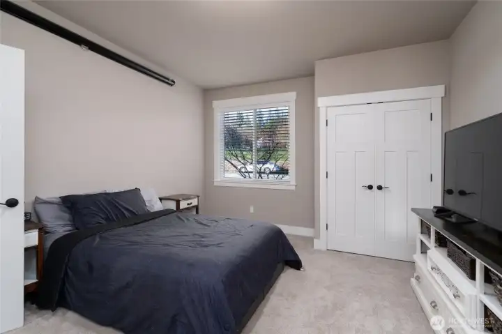 Comfortable bedroom with natural light and neutral finishes