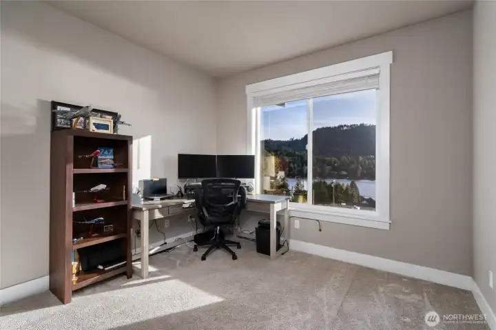 Home office with lake views and dual monitors workspace