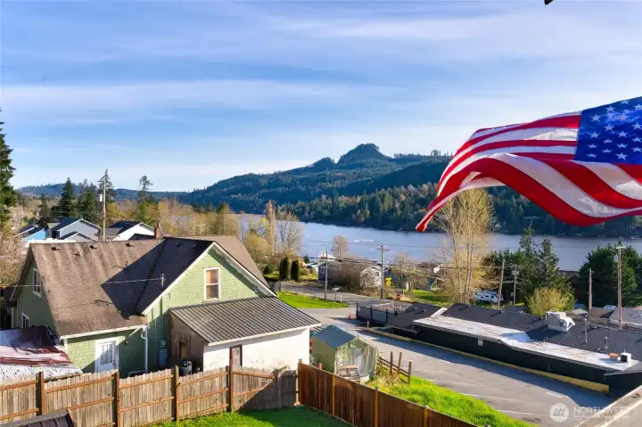 Scenic lake and mountain views with American flag on deck