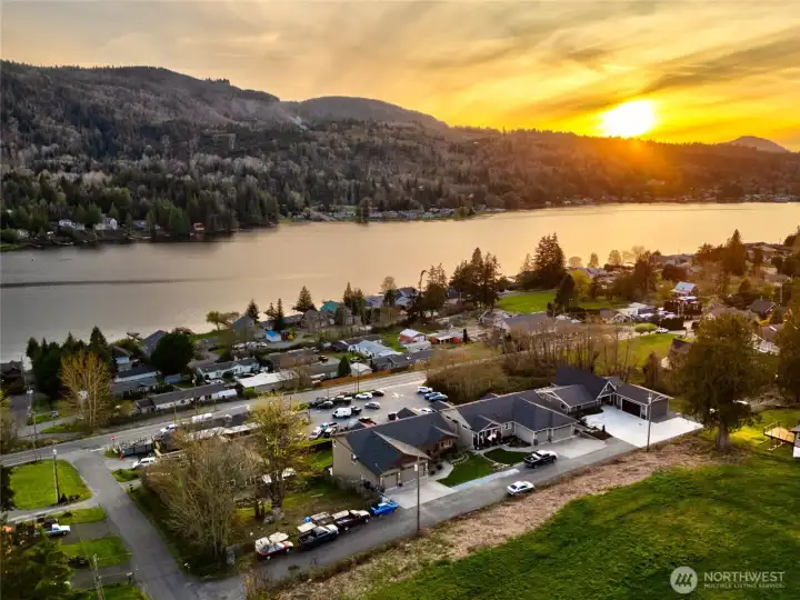 Stunning aerial lake view with sunset and scenic mountain backdrop