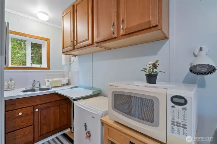 Cabinets for added storage. Space for mini fridge and microwave.