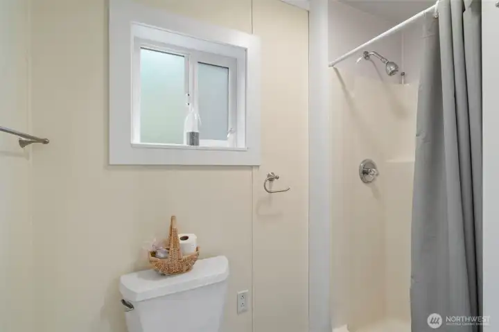 Light & bright bathroom with toilet and full size shower. Baseboard heating for added comfort on chilly days & nights.