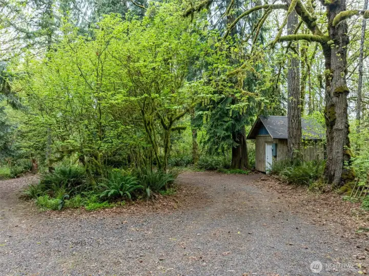 Pump house located to the right of the driveway.