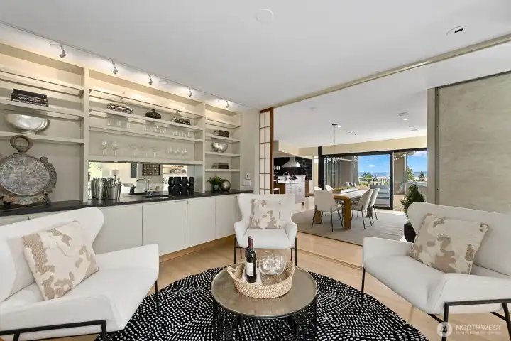 Stylish conversation area with built-in bar, custom shelving, and curated designer finishes—perfect for entertaining