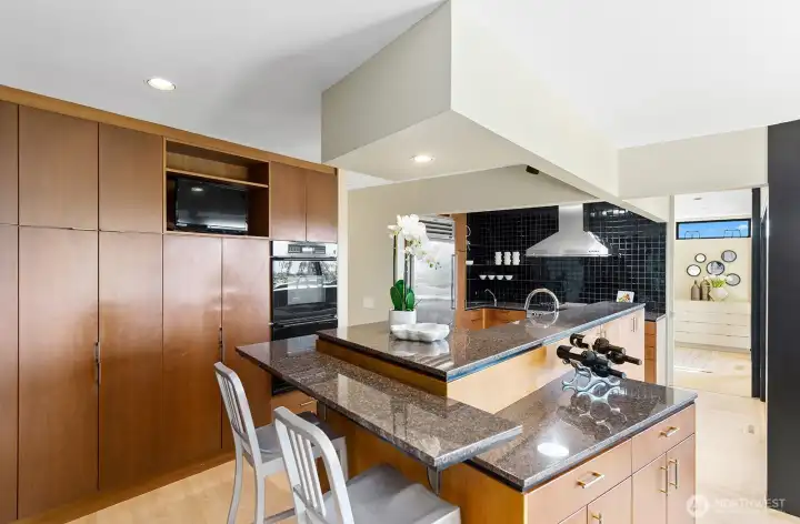 High-end kitchen with integrated appliances and warm wood cabinetry throughout