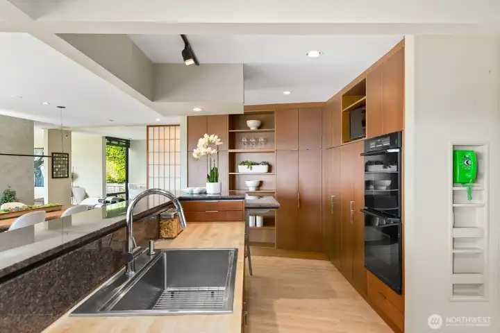 Kitchen opens seamlessly to living spaces, creating a perfect gathering hub