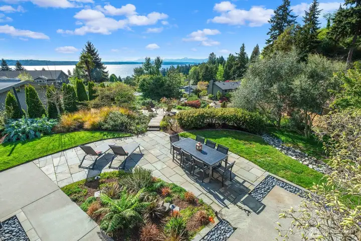 Thoughtfully designed outdoor living area with dining, lounge seating, and easy access to the upper deck—ideal for entertaining in style