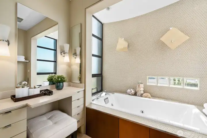 Spa-inspired bath with soaking tub, designer tile, and abundant natural light