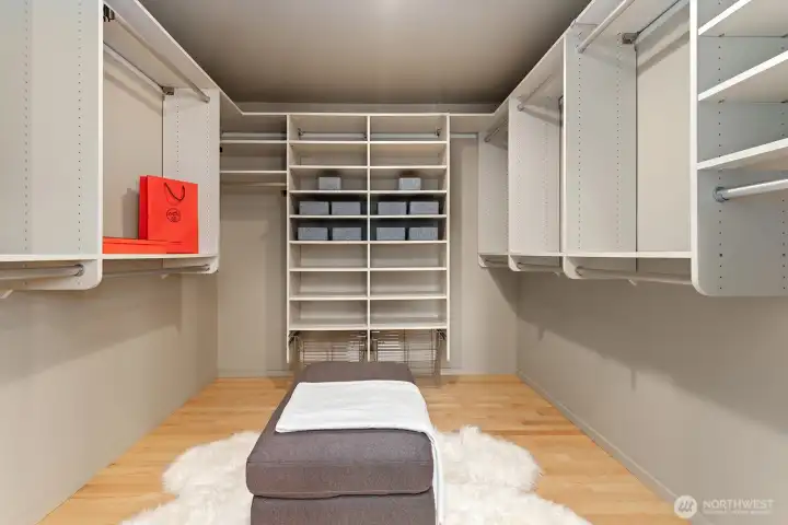 Spacious walk-in closet with custom built-ins, ample shelving, and organized storage throughout