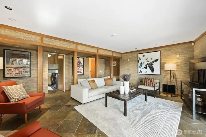 Spacious lower-level family room with warm wood detailing, slate floors, and flexible layout—conveniently located near laundry and ideal for relaxing or entertaining