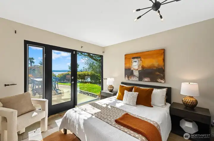 Serene bedroom with direct patio access and sound and mountain views