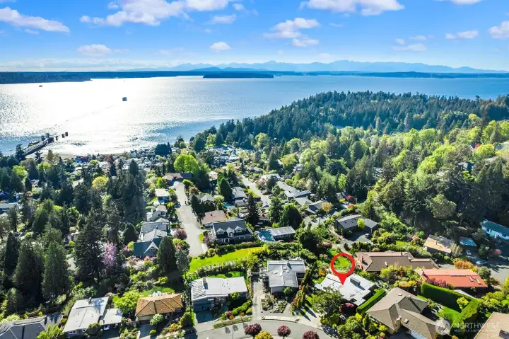 Panoramic water, mountain, and neighborhood views from this sought-after location