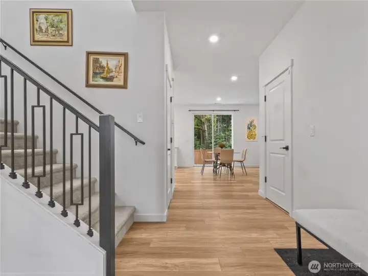 Another photo of the roomy entry with warm & welcoming flooring that flows throughout the home.