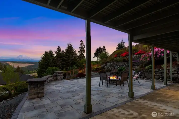 The lower level opens to a stunning paver patio with a built-in fire pit.