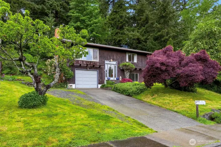 Mature landscaping and a sweeping lawn create instant privacy and curb appeal. Mature landscaping and a sweeping lawn create instant privacy and curb appeal.