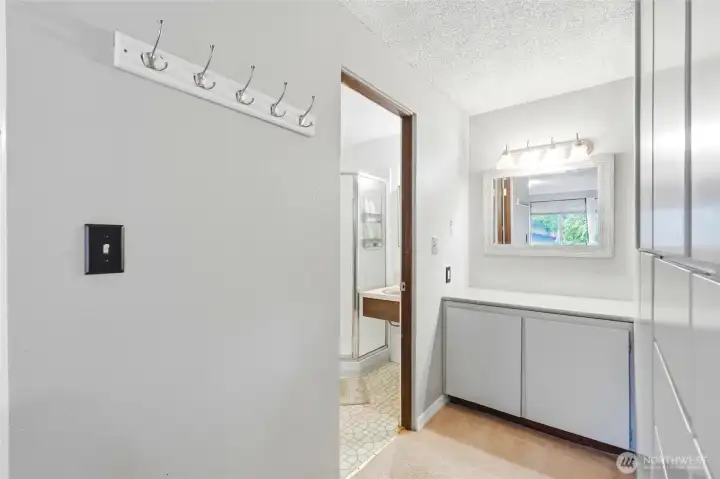 A dedicated dressing area off the primary bedroom with built-in storage and vanity space. A dedicated dressing area off the primary bedroom with built-in storage and vanity space.