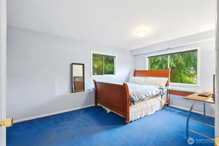 A true lower-level bedroom with greenery views gives guests or family members their own private corner of the home. A true lower-level bedroom with greenery views gives guests or family members their own private corner of the home.