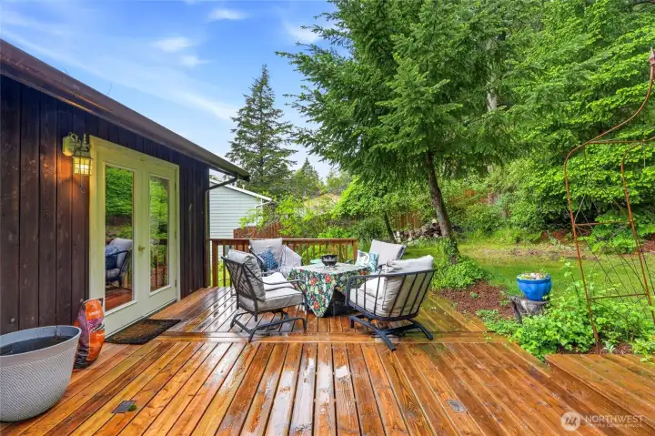 The deck flows directly off the kitchen and dining area through French doors, so hosting outside is as easy as swinging them open. The deck flows directly off the kitchen and dining area through French doors, so hosting outside is as easy as swinging them open.