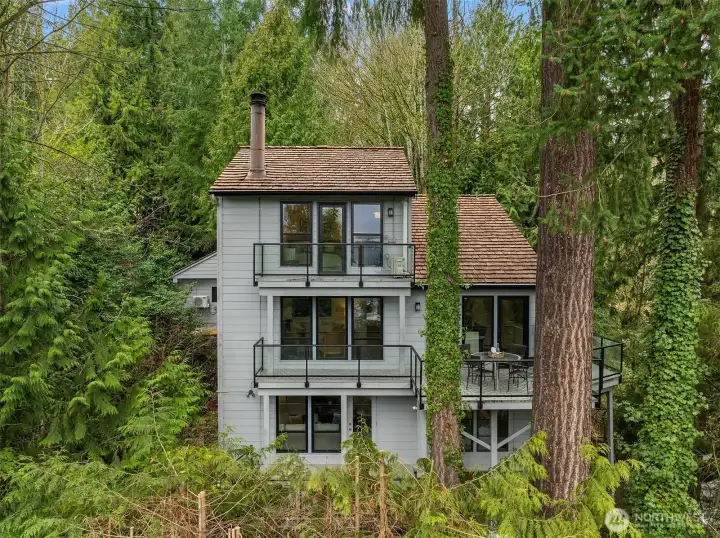 Three levels of living with expansive decks and serene Pacific Northwest setting