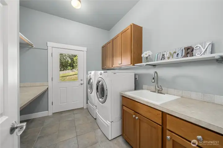 Laundry with folding table, sink & private door to backyard Laundry with folding table, sink & private door to backyard