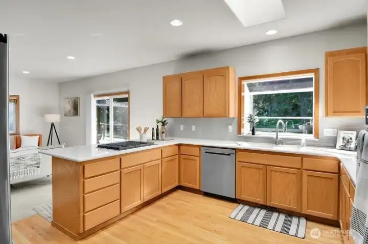 Kitchen features quartz counters and a tile backsplash