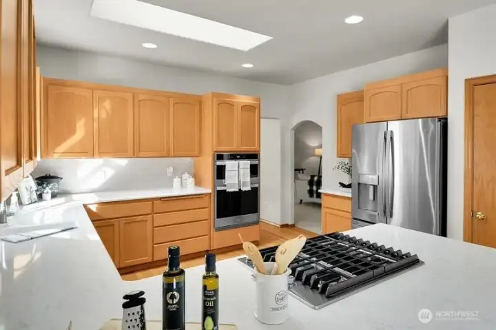 Newer stainless steel appliances highlight the kitchen