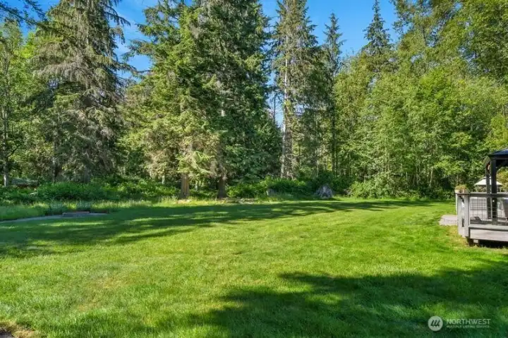 The level, park-like back yard offers a true feeling of privacy