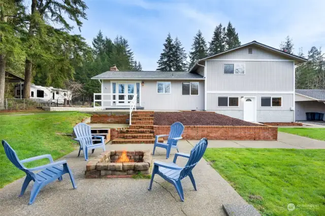 View of the Back of the Home.  Lovely Deck and also this Patio with Firepit!