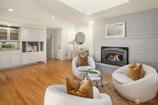 Second main level gas fireplace. The spacious family room flows between kitchen and main living. The door on the left goes to a powder room and the other to the garage.