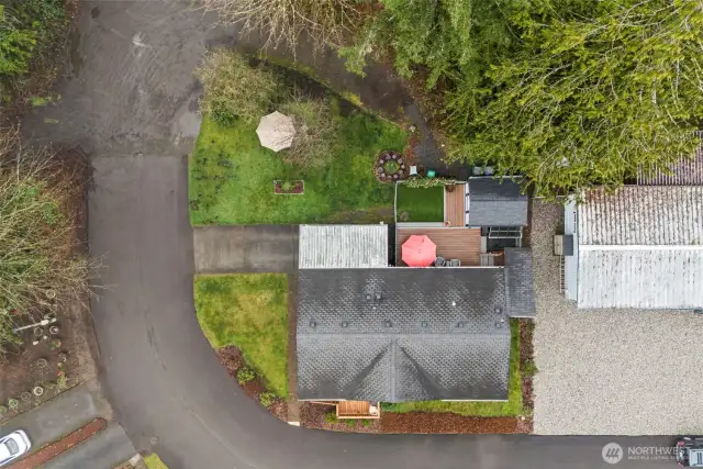 Drone perspective showing the home's thoughtful positioning and lush surroundings.