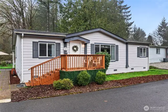 Fresh exterior with a welcoming front porch and modern color palette.
