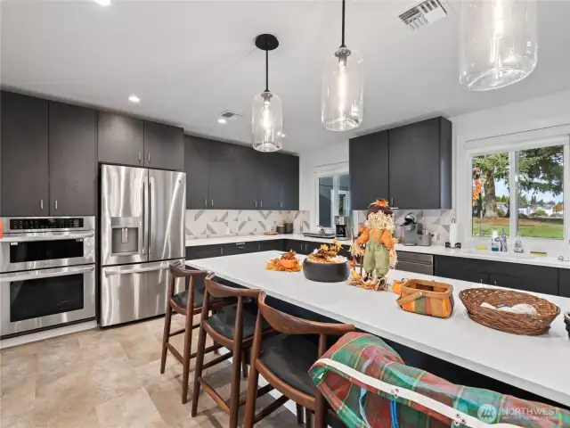 Sleek and stylish, the clubhouse kitchen is fully equipped with stainless appliances and ample seating—perfect for community events and private gatherings.