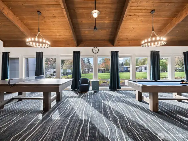 Whether it’s pool or ping pong, enjoy the natural light and vibrant ambiance of this well-appointed game room.