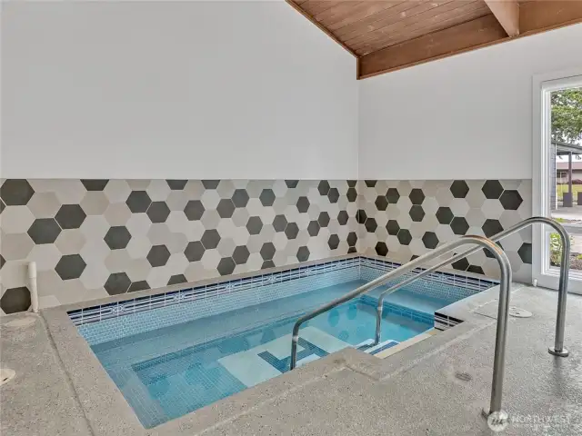 Soothe your muscles in the indoor hot tub, surrounded by stylish hexagonal tile and natural light.