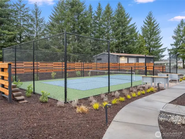 Stay active and social with a match on the brand-new pickleball court, surrounded by lush landscaping and nearby seating.