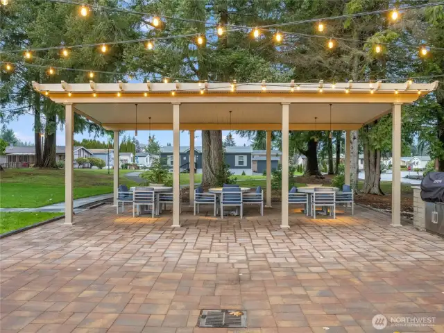 Gather under the lights! The covered outdoor dining area is ideal for potlucks, BBQ nights, or a quiet afternoon with friends.