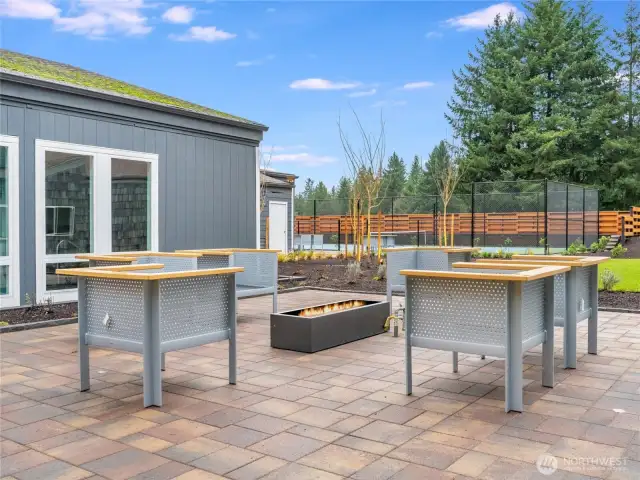 Relax under the stars around the modern firepit lounge—an ideal spot for evening chats and community connections.